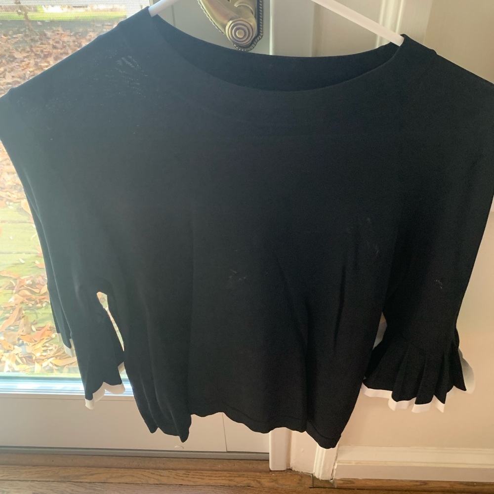 Great simple black work top with fun flared sleeves and white trim.